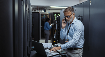 Man working on laptop in CDW server room